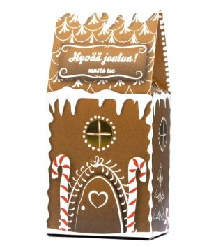 Kuva koristellun piparitalon muotoisesta teepaketista, jossa lukee ”Hyvää joulua!”