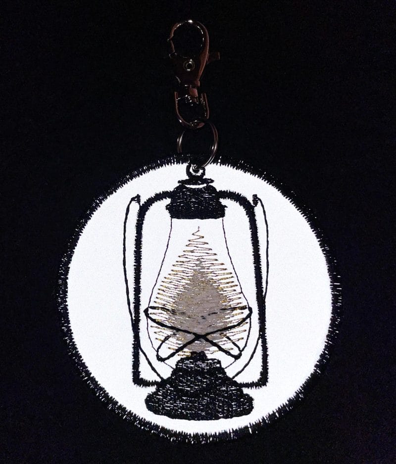 Handcrafted reflective pendant in dark.