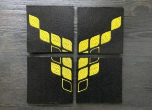 4 lasinalusesta koostuva hiisin keltainen logo mustalla pohjalla.